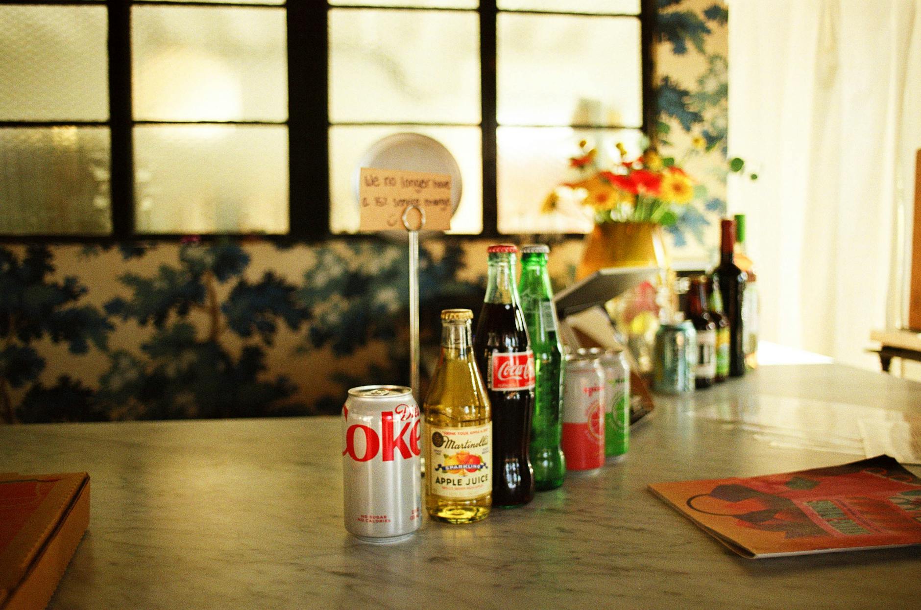 Sanpellegrino sparkling citrus drink cans arranged on marble countertop