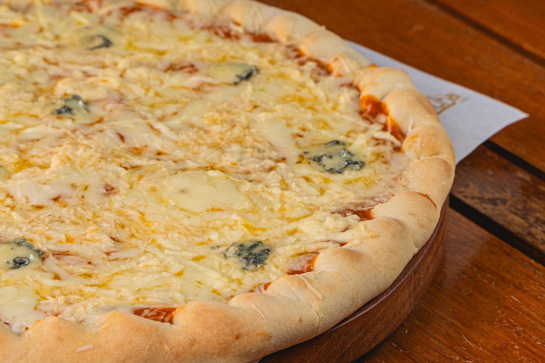 Four cheese pizza with golden melted cheese blend on thin crispy crust