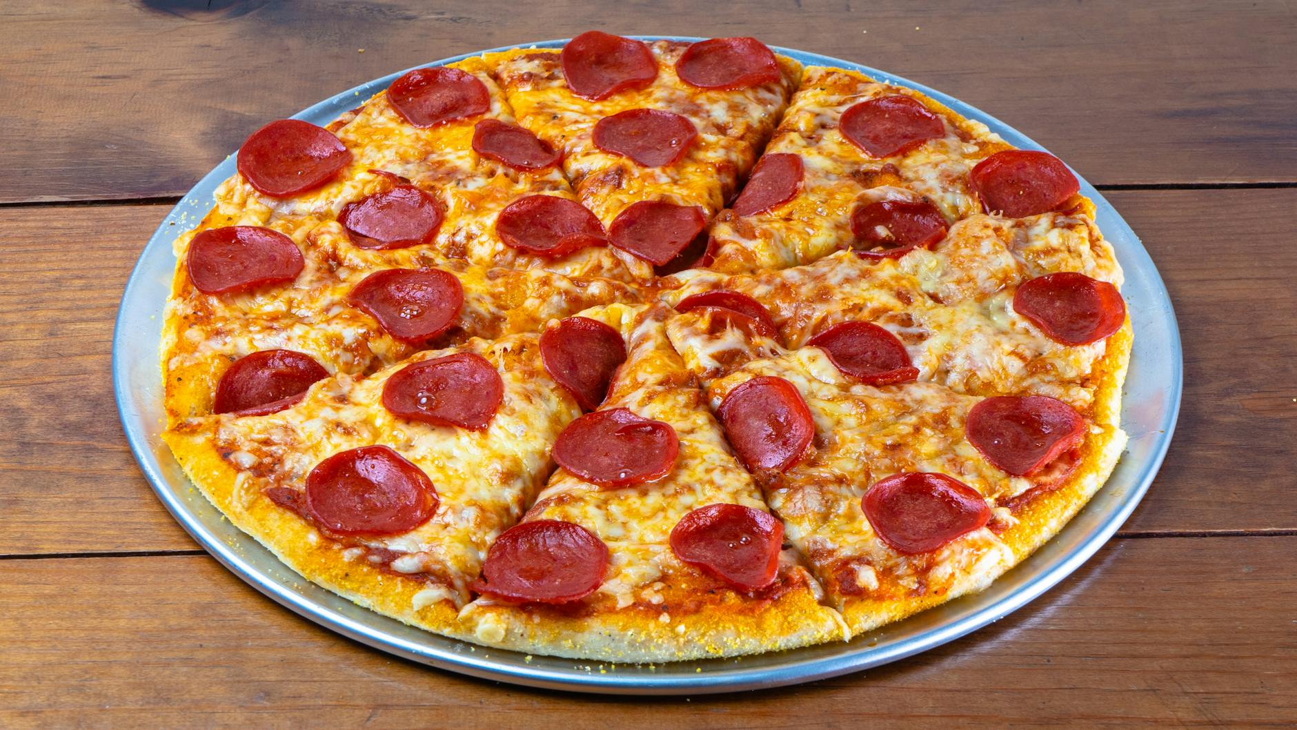 Classic pepperoni pizza with overlapping slices on melted mozzarella